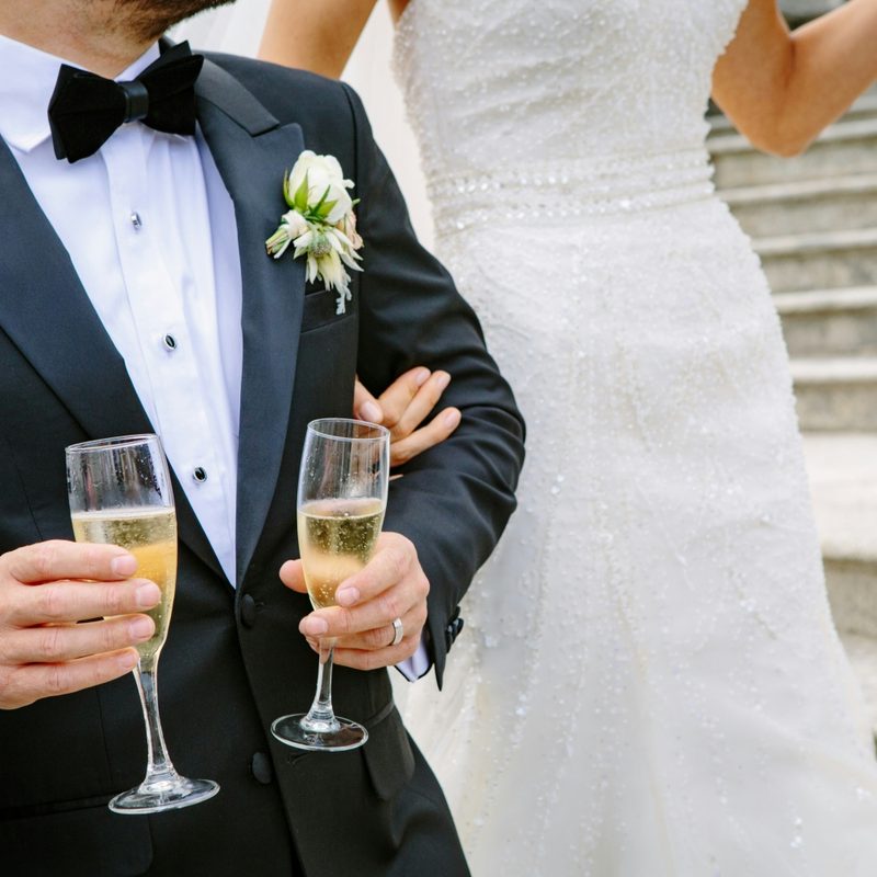 Man in a tuxedo carrying Champagne
