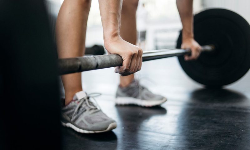 man lifting a barbell