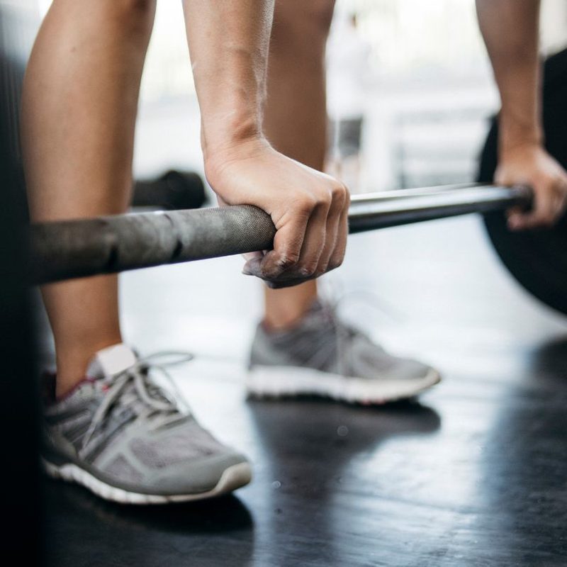 man lifting a barbell