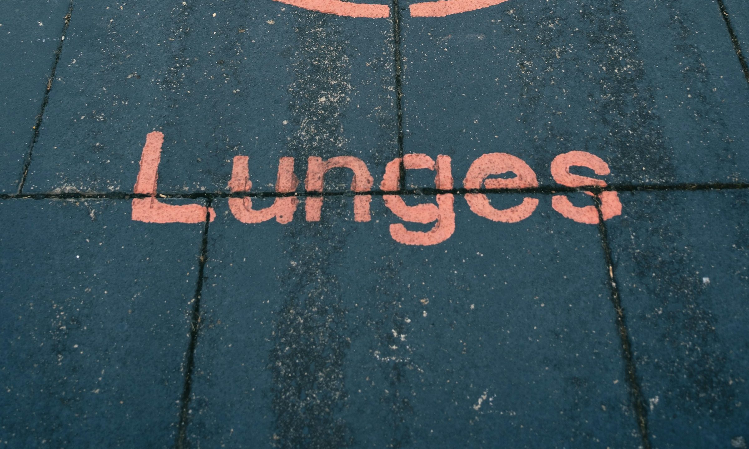 sign on ground in red saying lunges with illustration