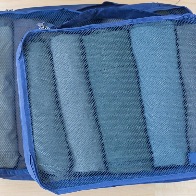 Cube meshed bags with rolled clothes, t-shirt, pants.