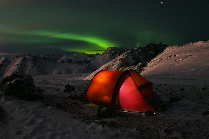 Tent camping in the winter with northern lights