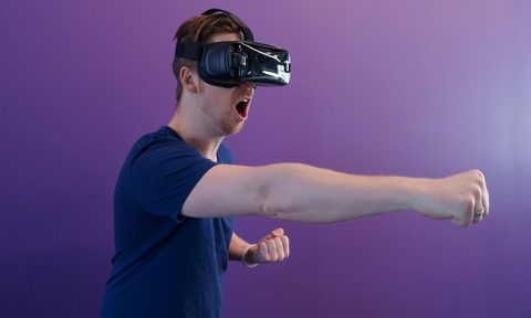 man wearing VR headset punching boxing fighting workout fitness virtual reality