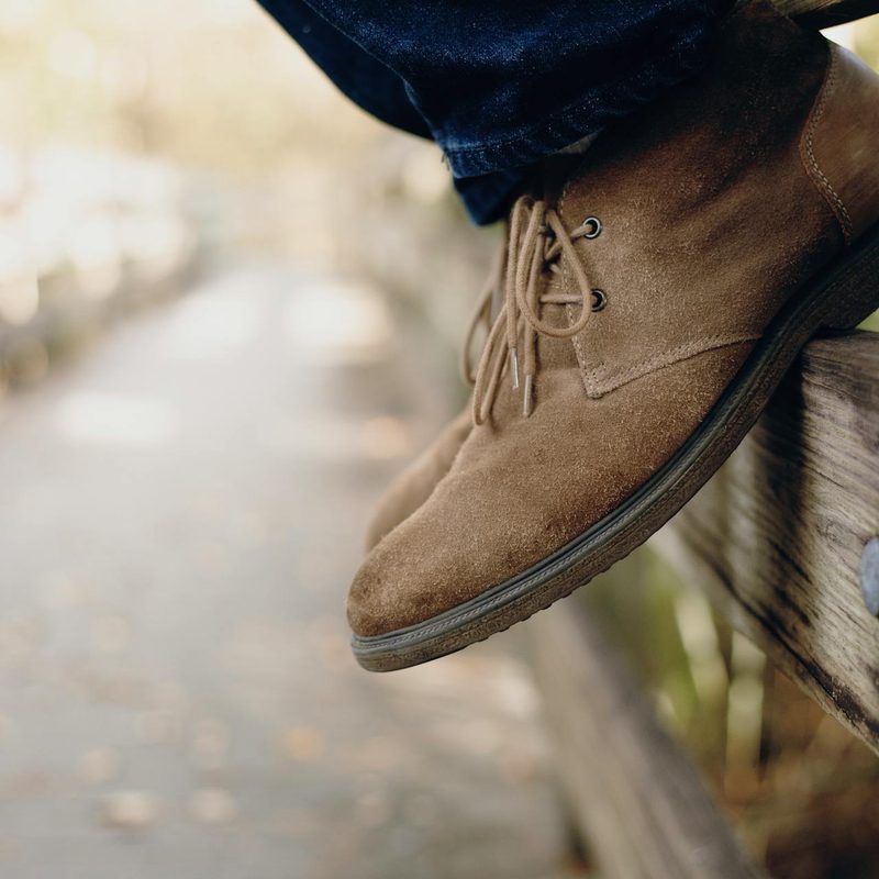 Close-up of person wearing chukka boots
