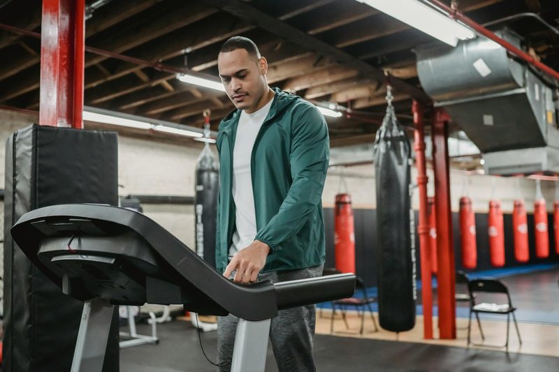 Man on treadmill walking using machine in gym
