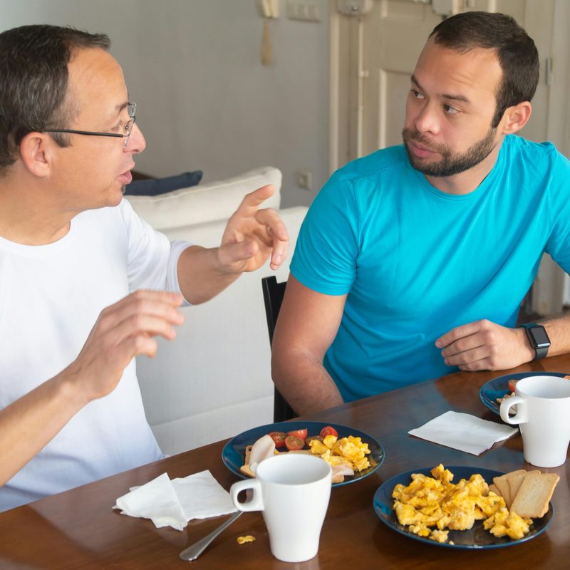 Men eating scrambled eggs.