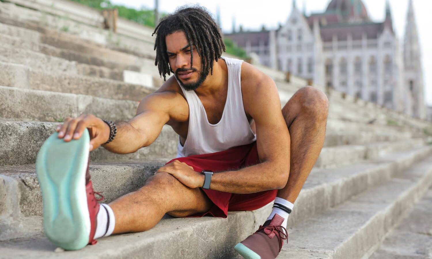 Man stretching in workout clothes.