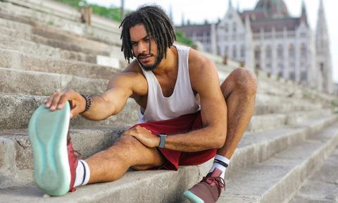 Man stretching in workout clothes