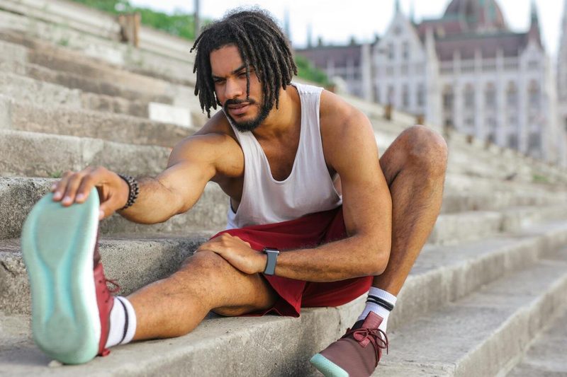 Man stretching in workout clothes