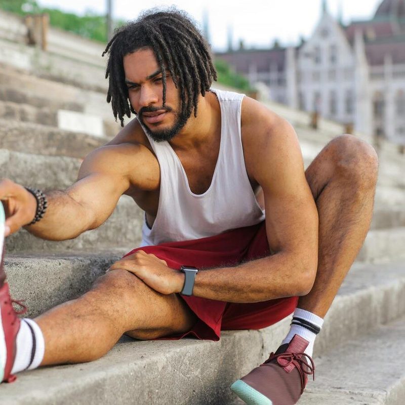 Man stretching in workout clothes