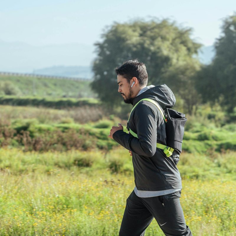 Man jogging brisk walking outdoors in nature