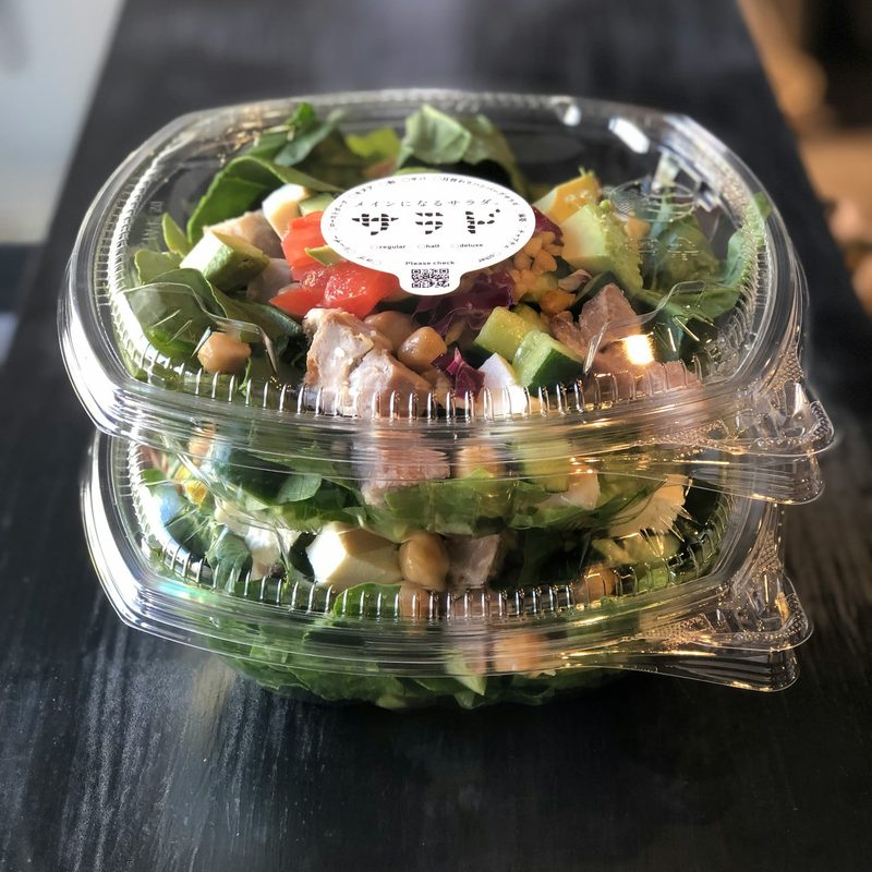 salad in a clear takeout container