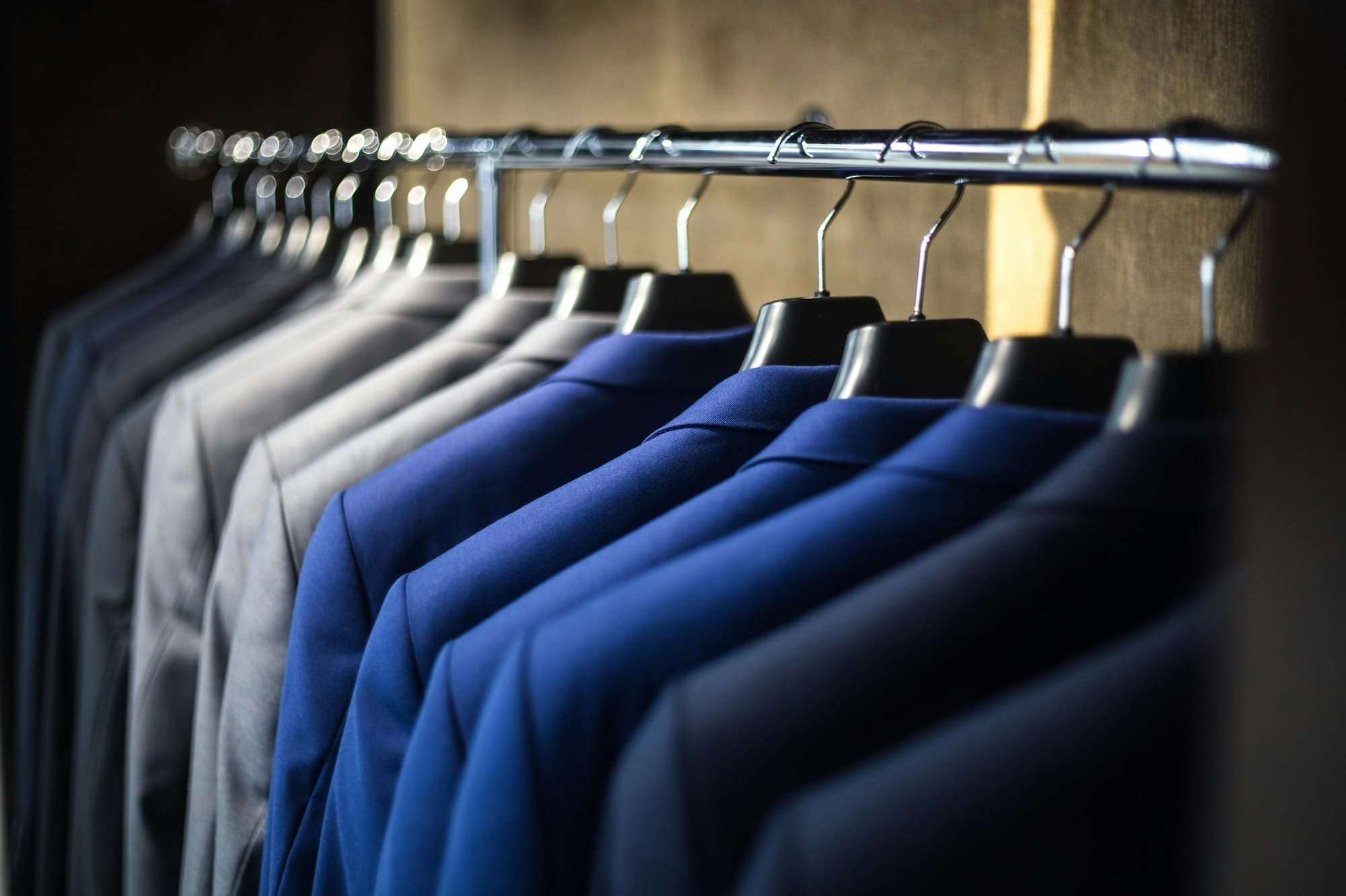suit jackets hanging up next to each other