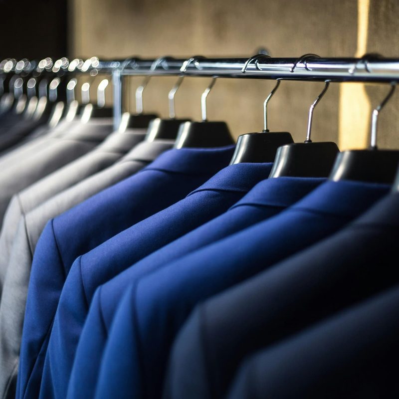 Suit jackets hanging up next to each other