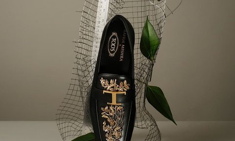 Rahul Tod's black loafer standing on toe against platform