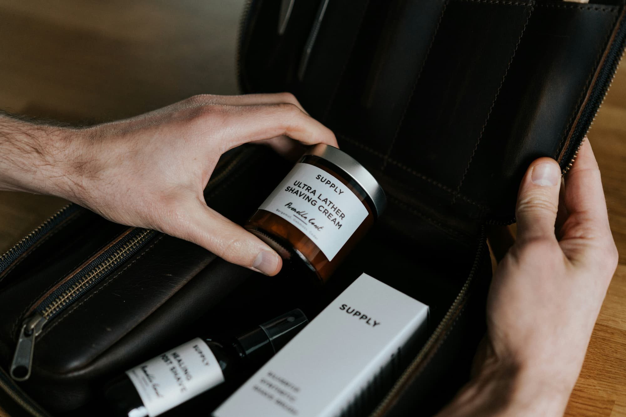man packing personal case essentials in a bag