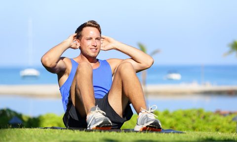 Man doing sit ups in the park
