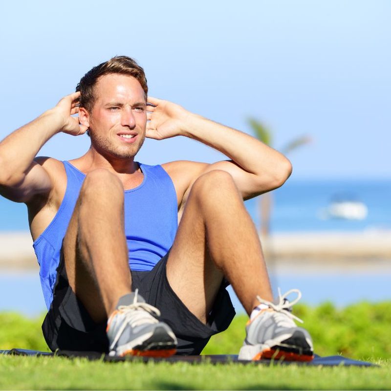Man doing sit ups in the park