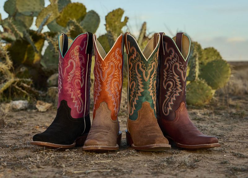 cowboy boots sitting on dirt