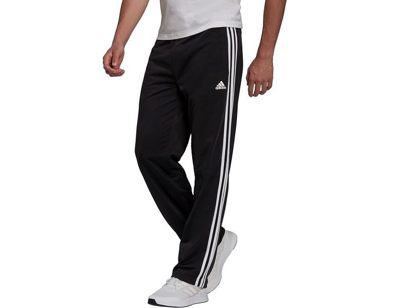 A model wearing the Adidas Men's Essentials Warm-up Open Hem 3-stripes Tracksuit Pants.