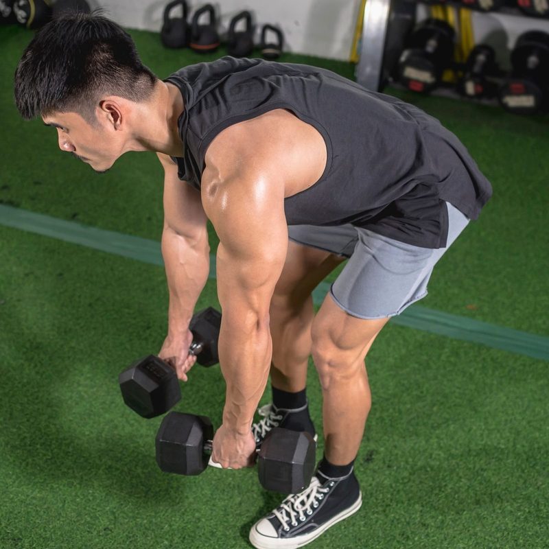 Man does dumbbell Romanian deadlift exercise RDL in gym MDV Edwards Adobe