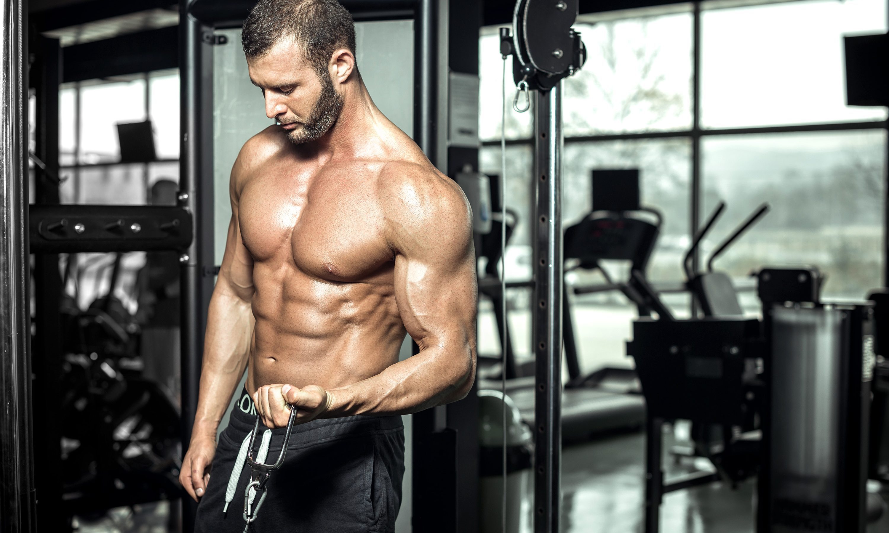 shirtless muscle man muscular in gym doing cable bicep curl cable machine