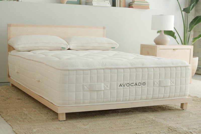 An Avocado Green Organic Plus Mattress with pillows on top.
