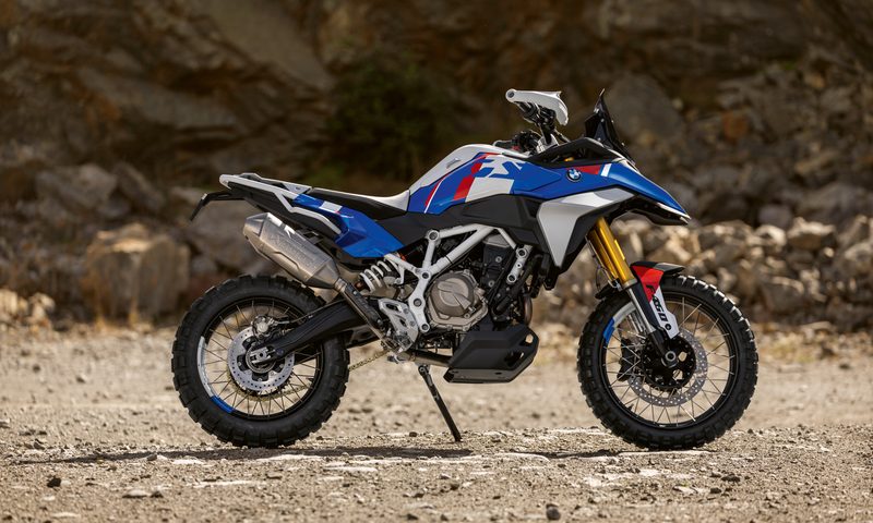 BMW Motorrad BMW Concept F 450 GS parked on dirt with a mountainside in the background.