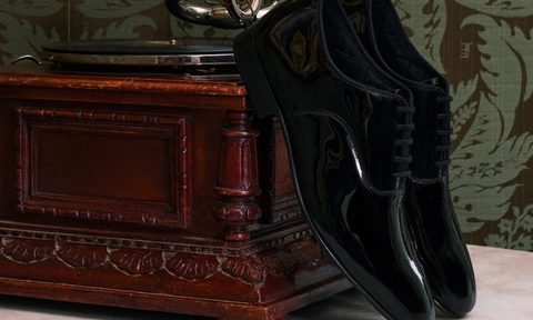 patent leather oxford shoes next to music box