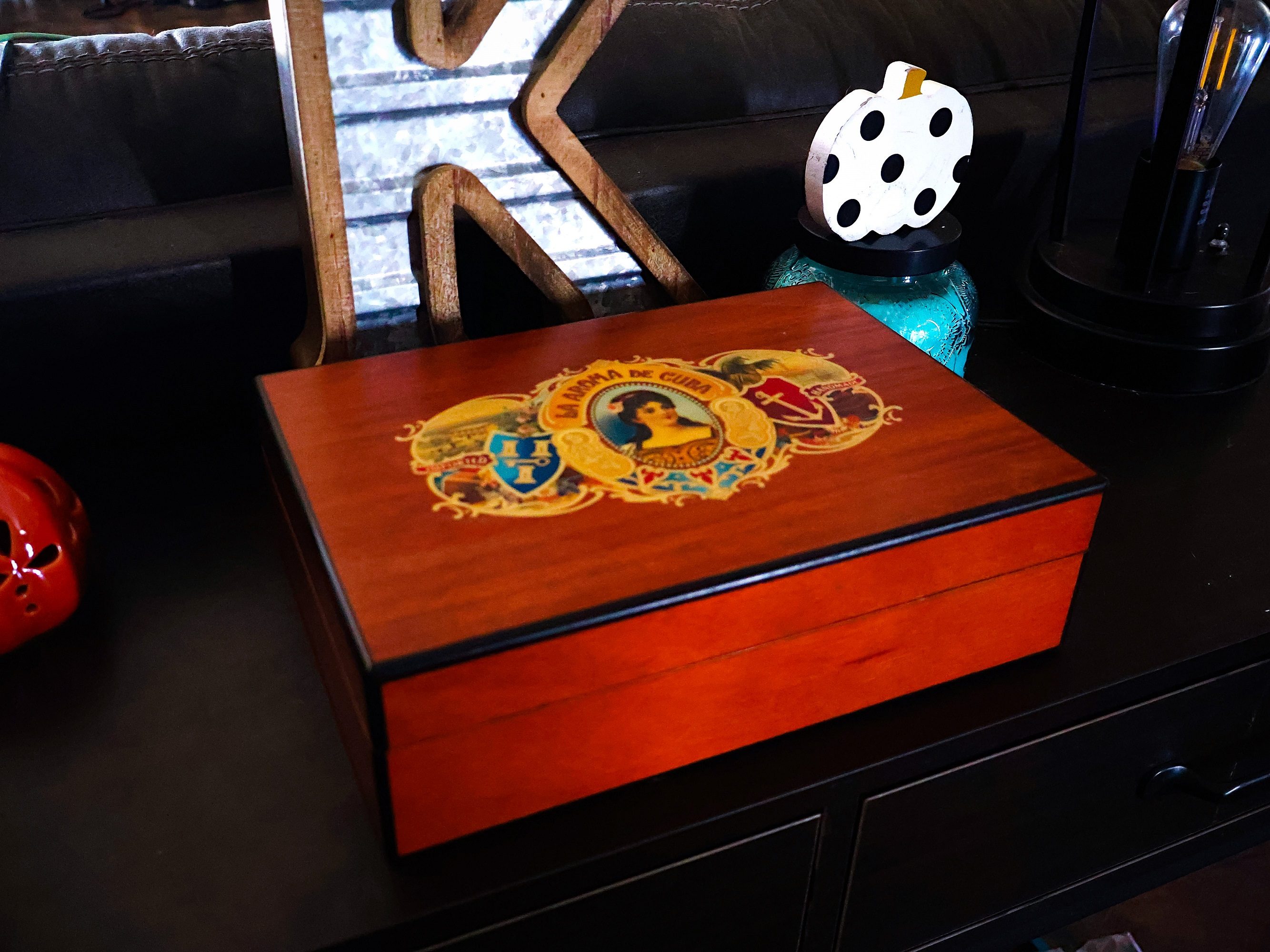 Desktop humidor on table behind couch -- The Manual by Briley Kenney