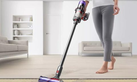 A person using the Dyson Digital Slim cordless vacuum.