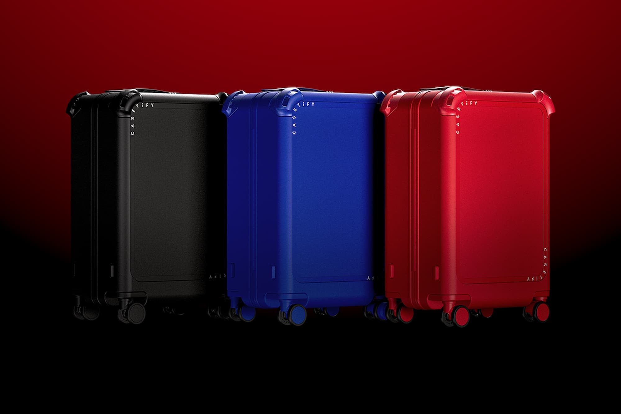 one black suitcase, one blue suitcase, and one red suitcase, all next to each other