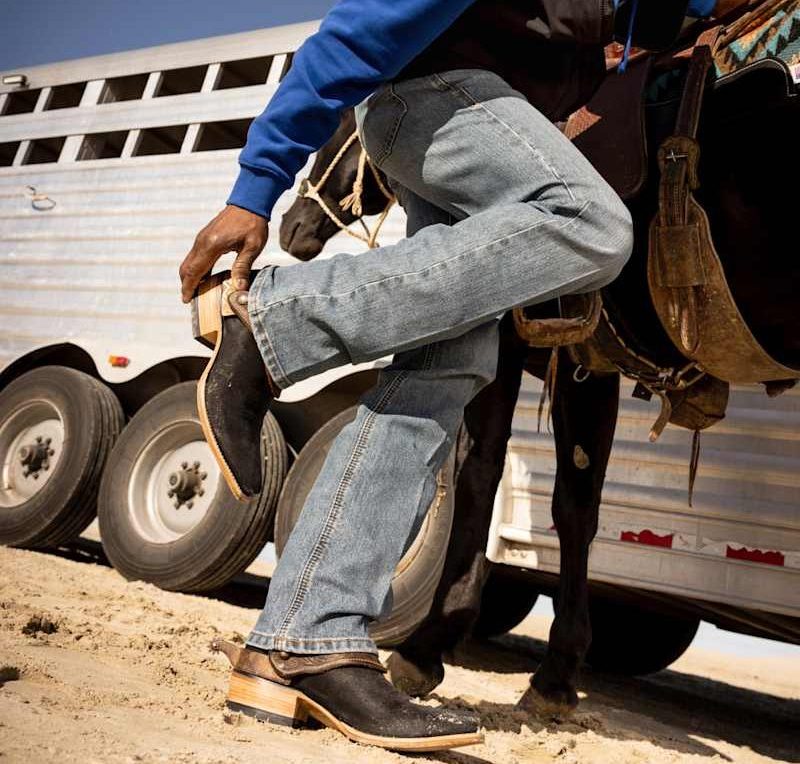 cowboy putting on cowboy boots