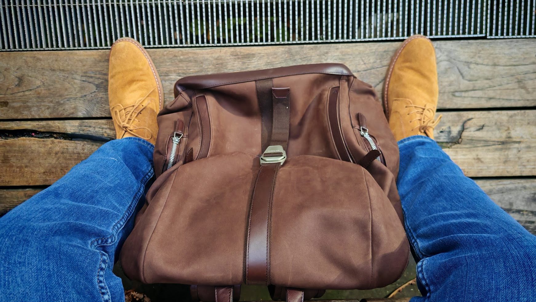 Carl Friedrik Traverse Backpack between a pair of legs