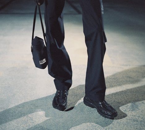 model wearing black sneakers