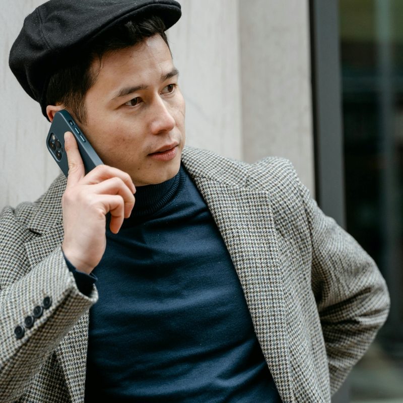 Man in green shirt and houndstooth jacket