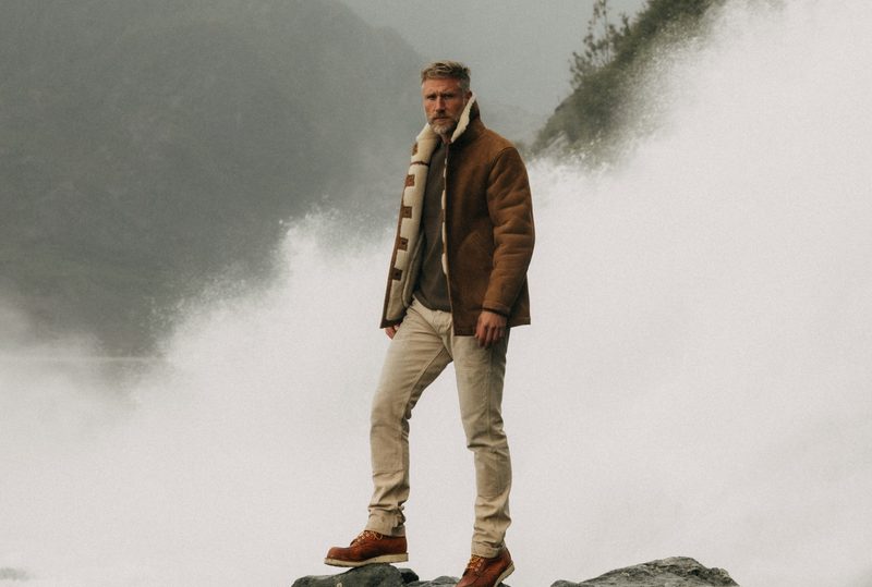 Man on rock wearing Taylor Stitch
