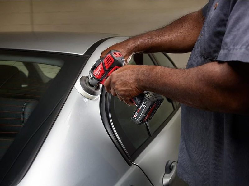 A man using a Milwaukee M12 Polisher on a car.