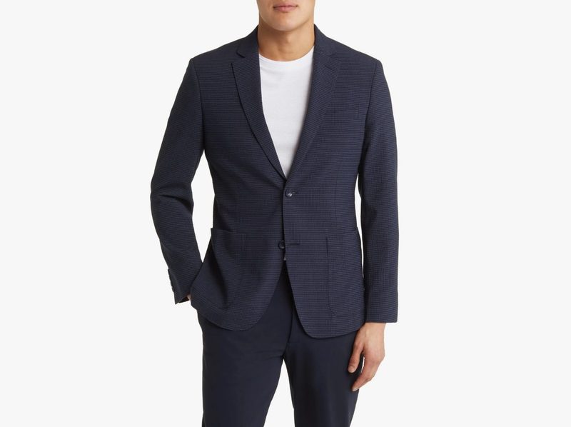 A man wearing Nordstrom's Patch Pocket Seersucker Sport Coat with a hand in his pants pocket.