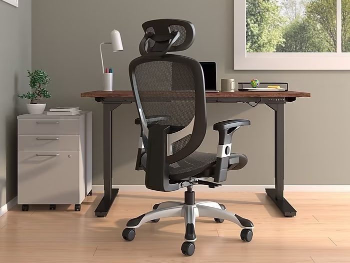 A Staples Hyken Ergonomic Mesh Swivel Task Chair in a home office.