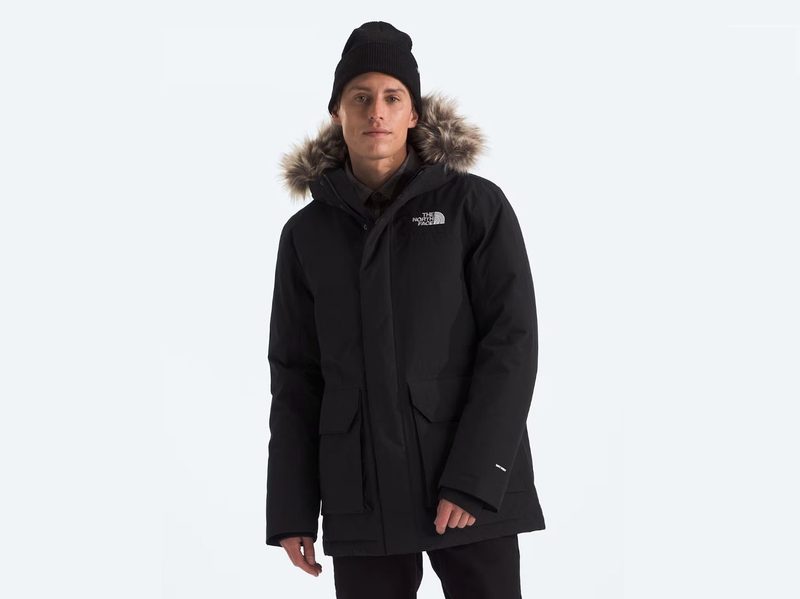 A man wear's The North Face Men's Explore Farther Parka with a hat on.