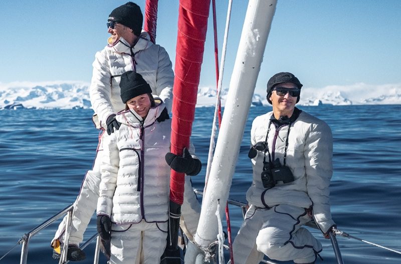 Three people wearing the North Face snow suit in white