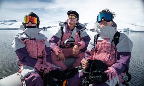 Three people wearing the North Face snow suit