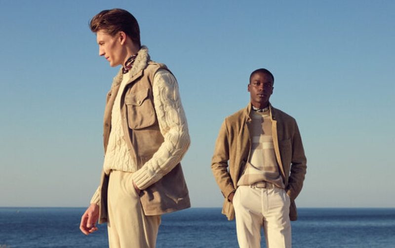 Two men in beige Paul Stuart looks on the beach