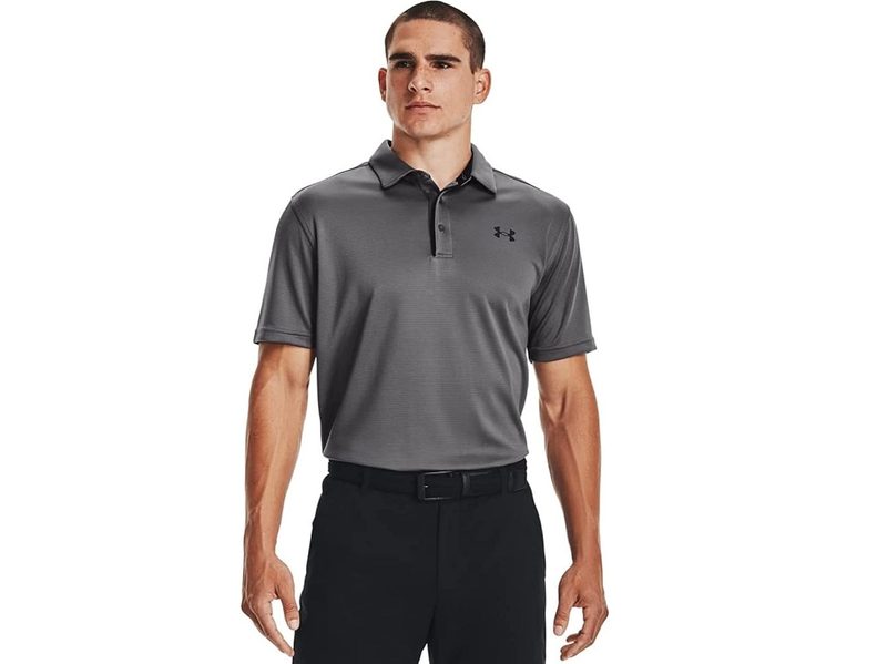 A model wearing the Under Armour Men's Tech Golf Polo.