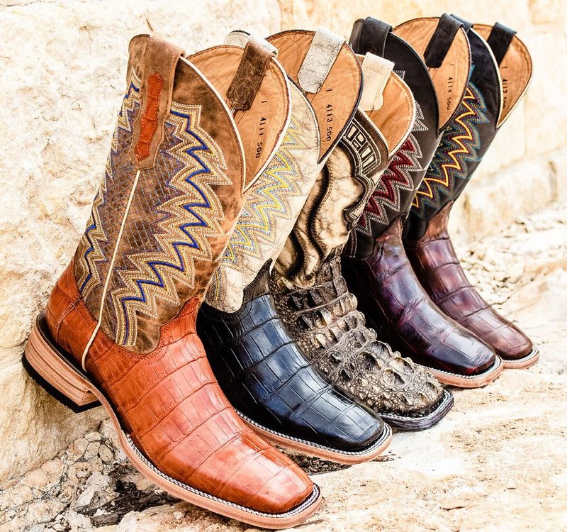 vaccari cowboy boots lined up on wall