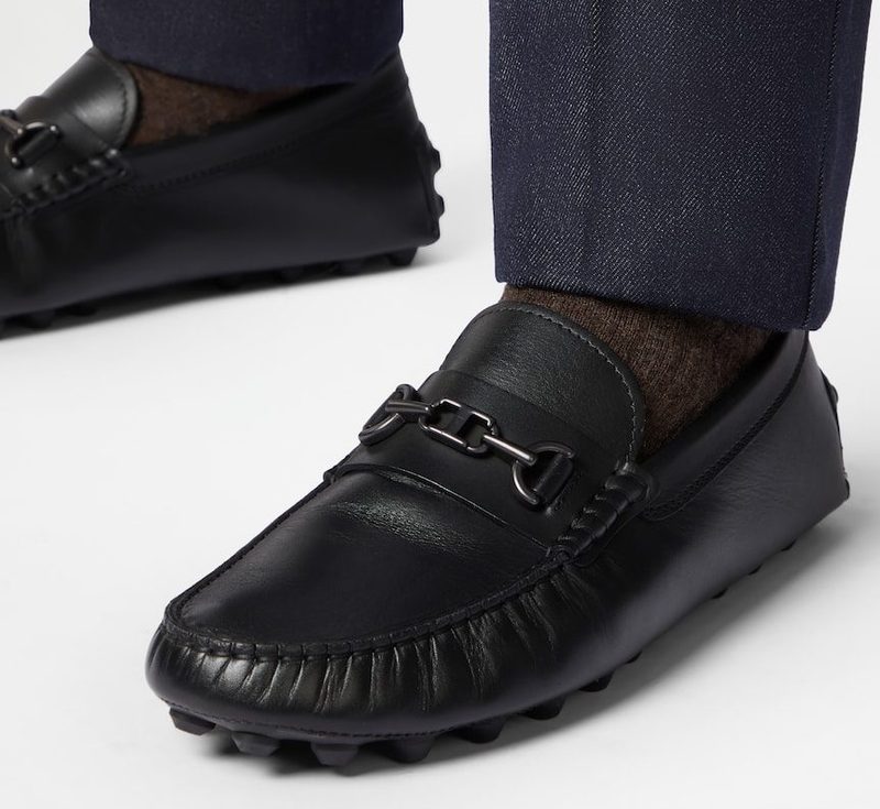 man wearing black pebble driving shoes