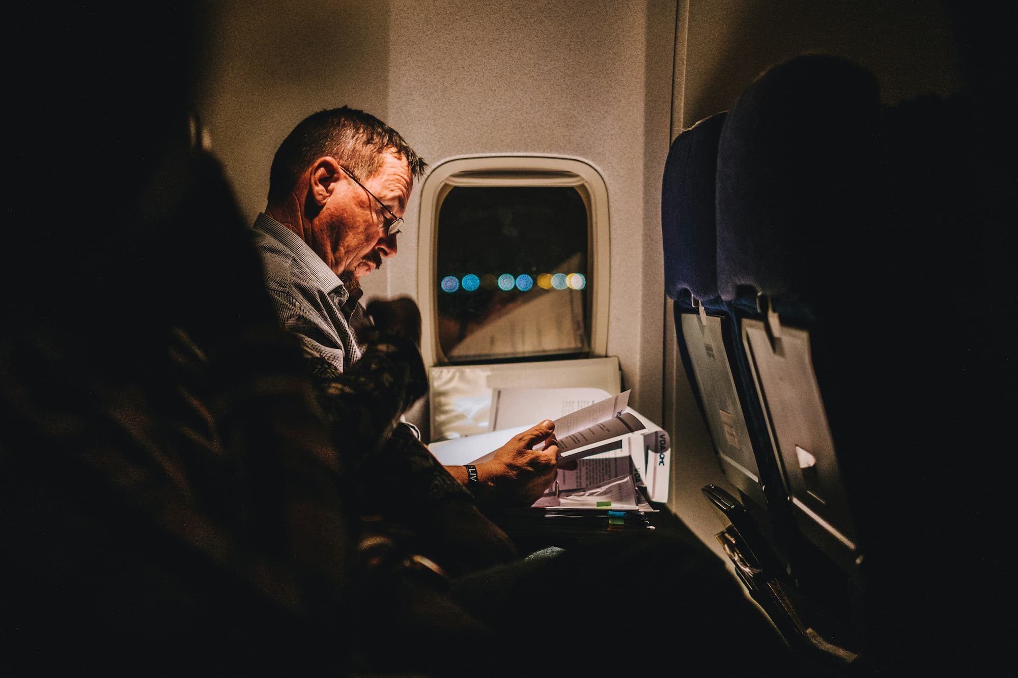 Man reading on a plane