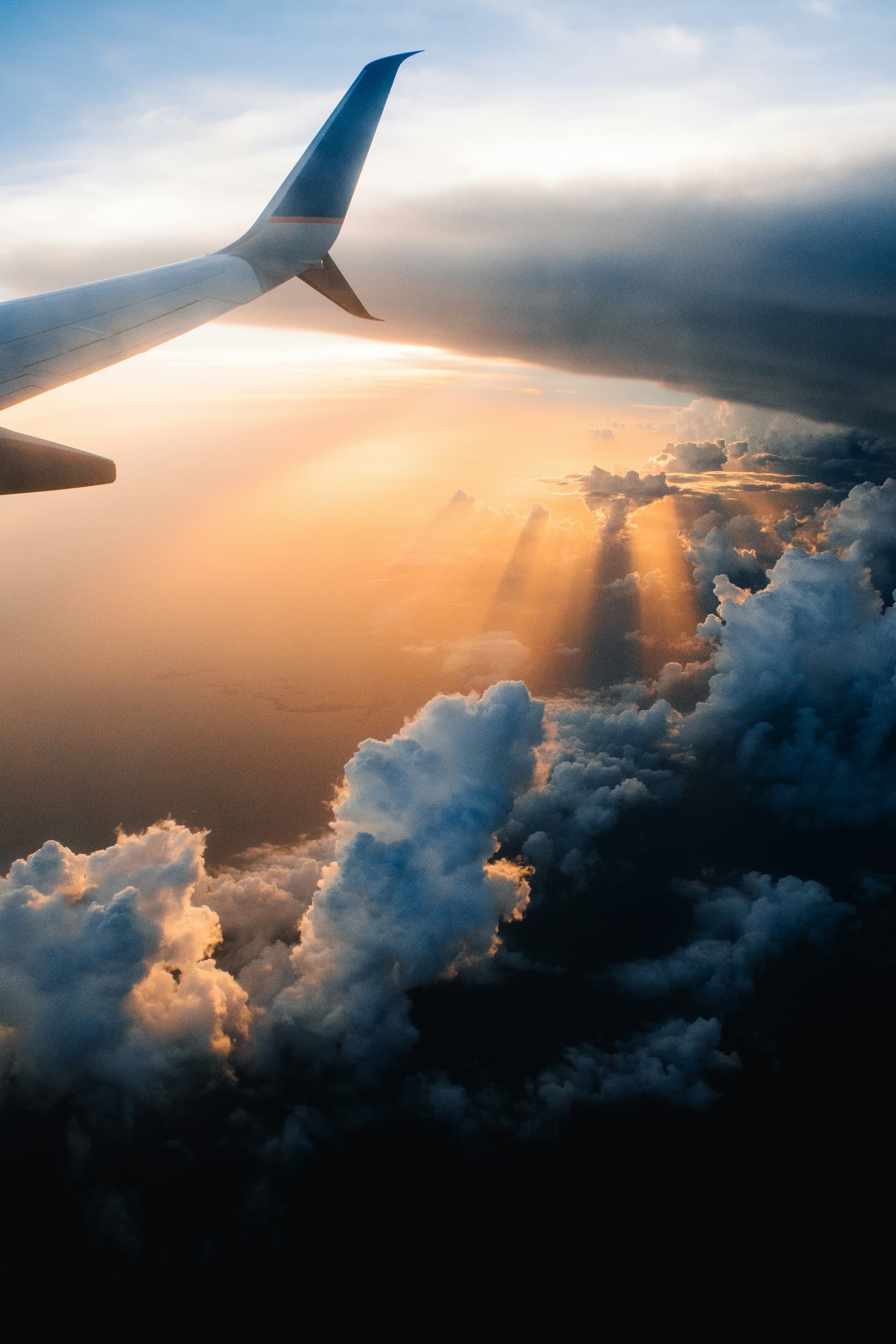 airplane flying in the sky during sunset