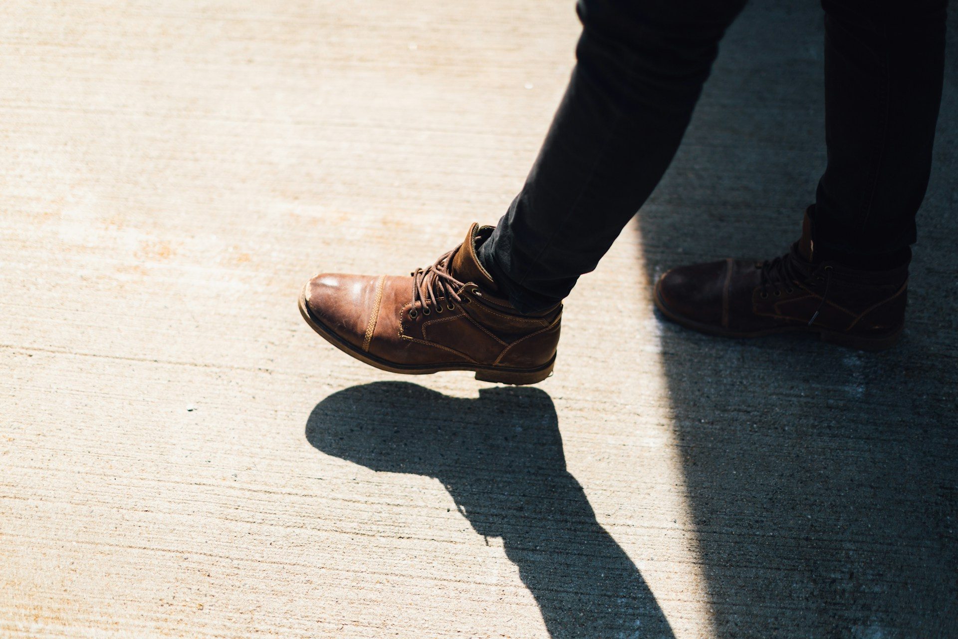 Person wearing brown leather ankle boots